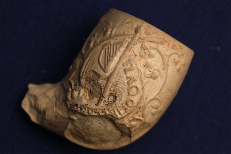 Shown is a decorated fragment of a pipe unearthed near a mass grave, in Malvern, Pa., at the Duffy's Cut Museum at Immaculata University, Tuesday, Feb. 28, 2012, in Immaculata, Pa. Researchers believe the mass grave contains the remains of about 50 Irish immigrants who died weeks after coming to Pennsylvania to build a railroad in 1832. (AP Photo/Matt Rourke)